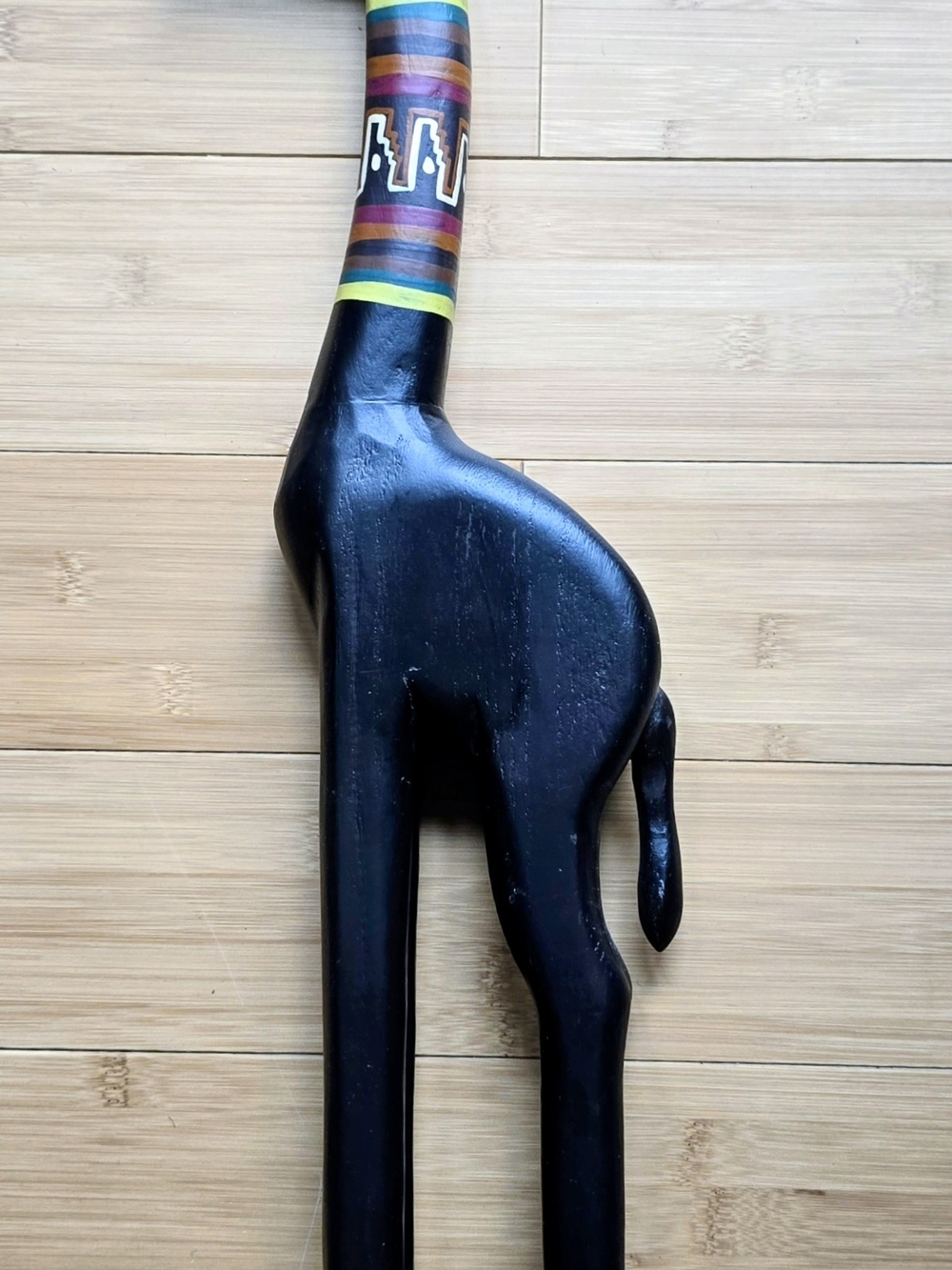 Black Wooden Giraffe Sculpture with Colorful Neck Accent